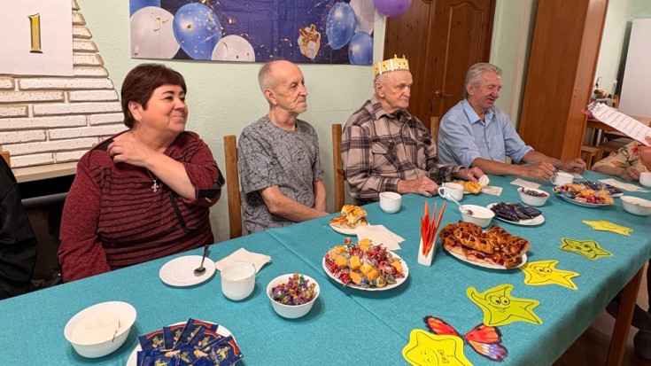 Проживающие отгадывают загадки за накрытым столом